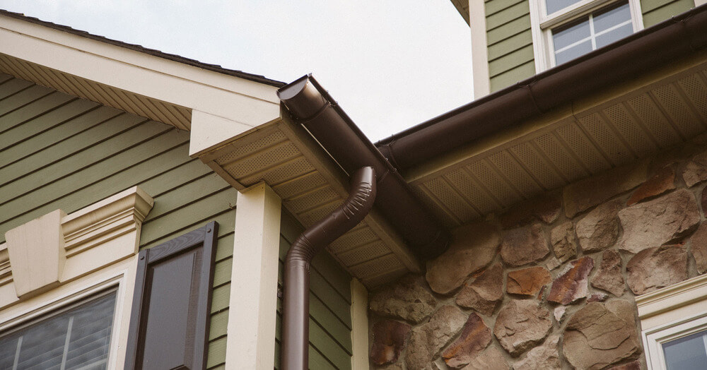 a gutter system with sealed gutter outlets on a house