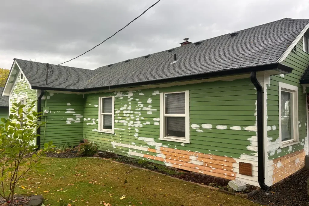 Gutter Installation St Helens 4 Green home exterior with gutters, downspouts, and siding preparation in St. Helens, OR