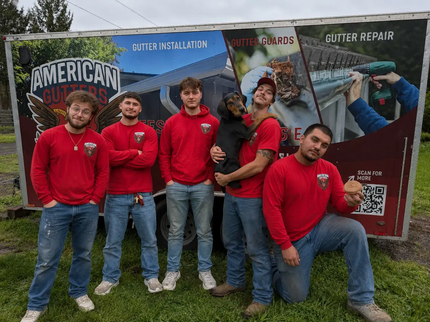 The American Gutter Service team in St. Helens, Oregon standing in front of the company trailer