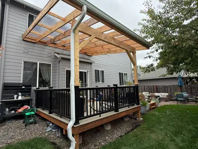 White downspout on the post of a pergola over a backyard deck in St. Helens